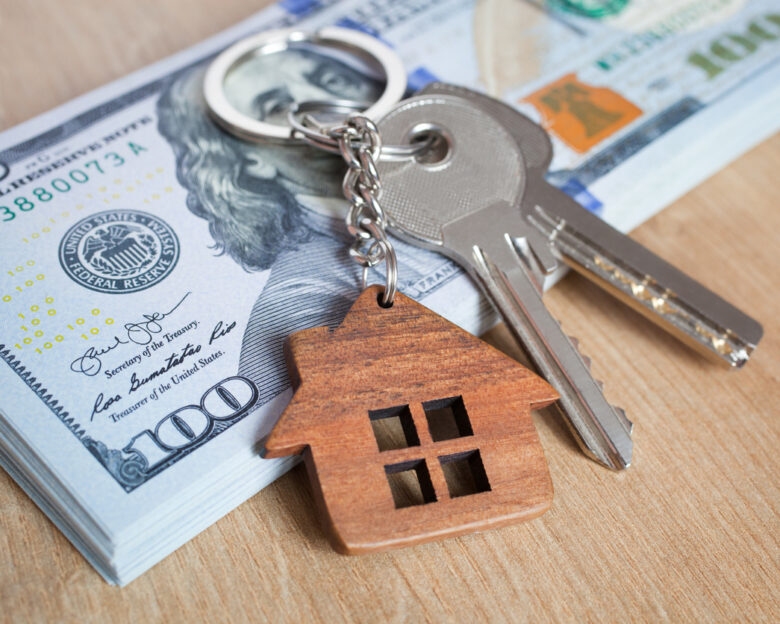 Real estate investing concept. American dollar, cash or housing. Keys close-up