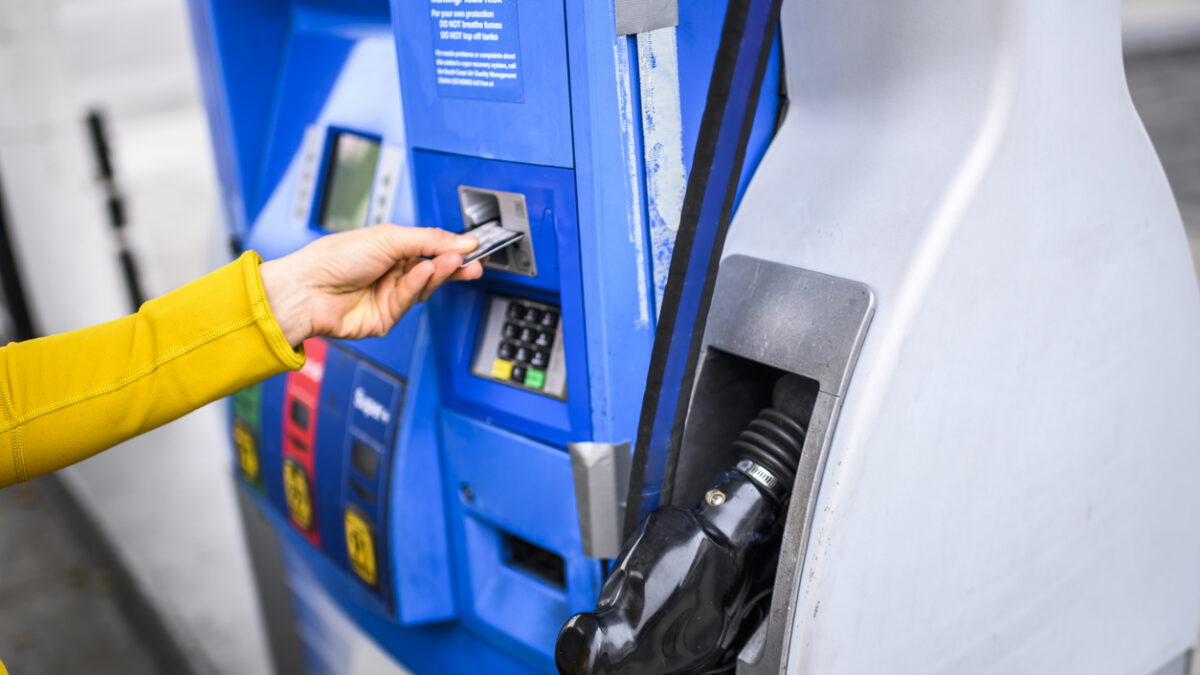 Making a payment for gas at a fuel station.