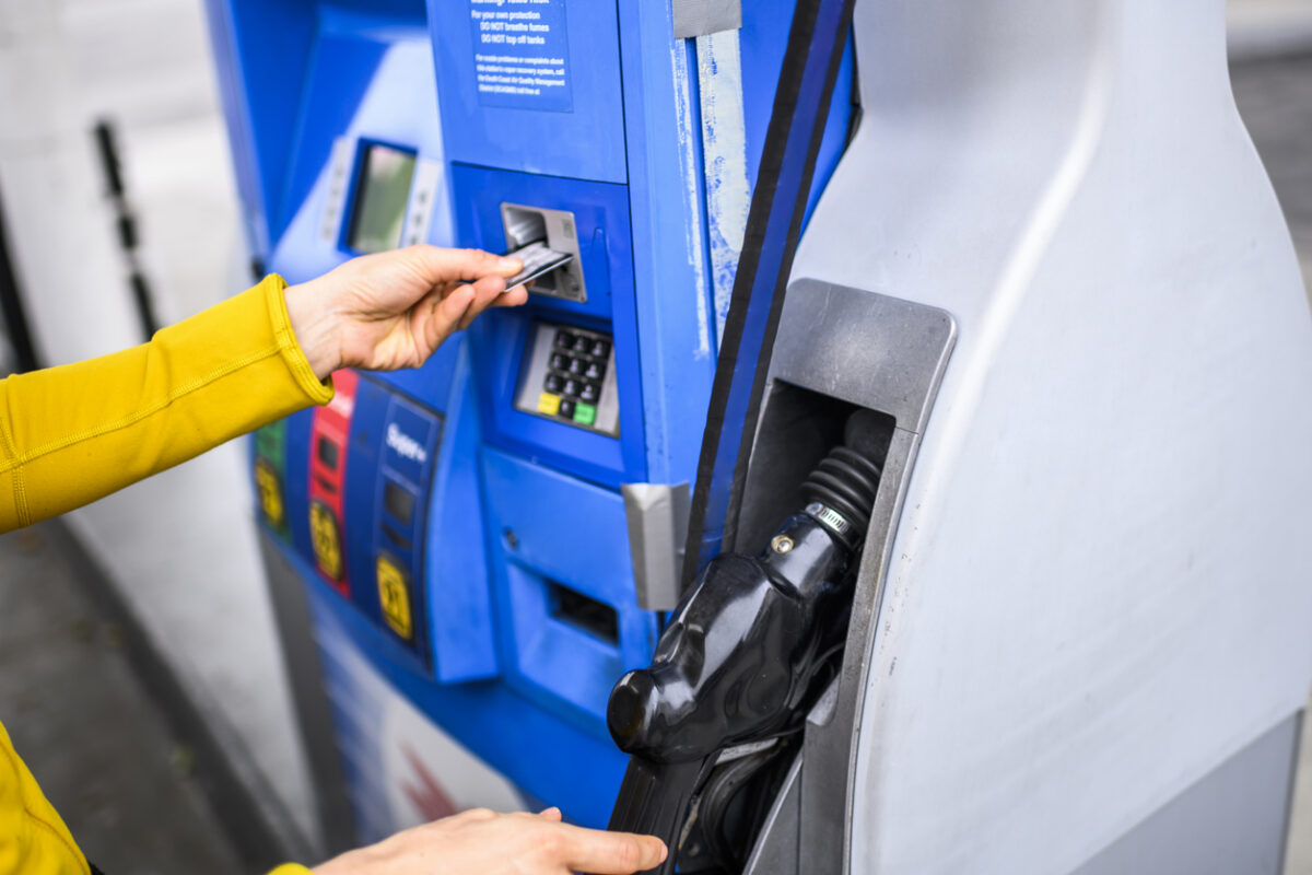 Making a payment for gas at a fuel station.