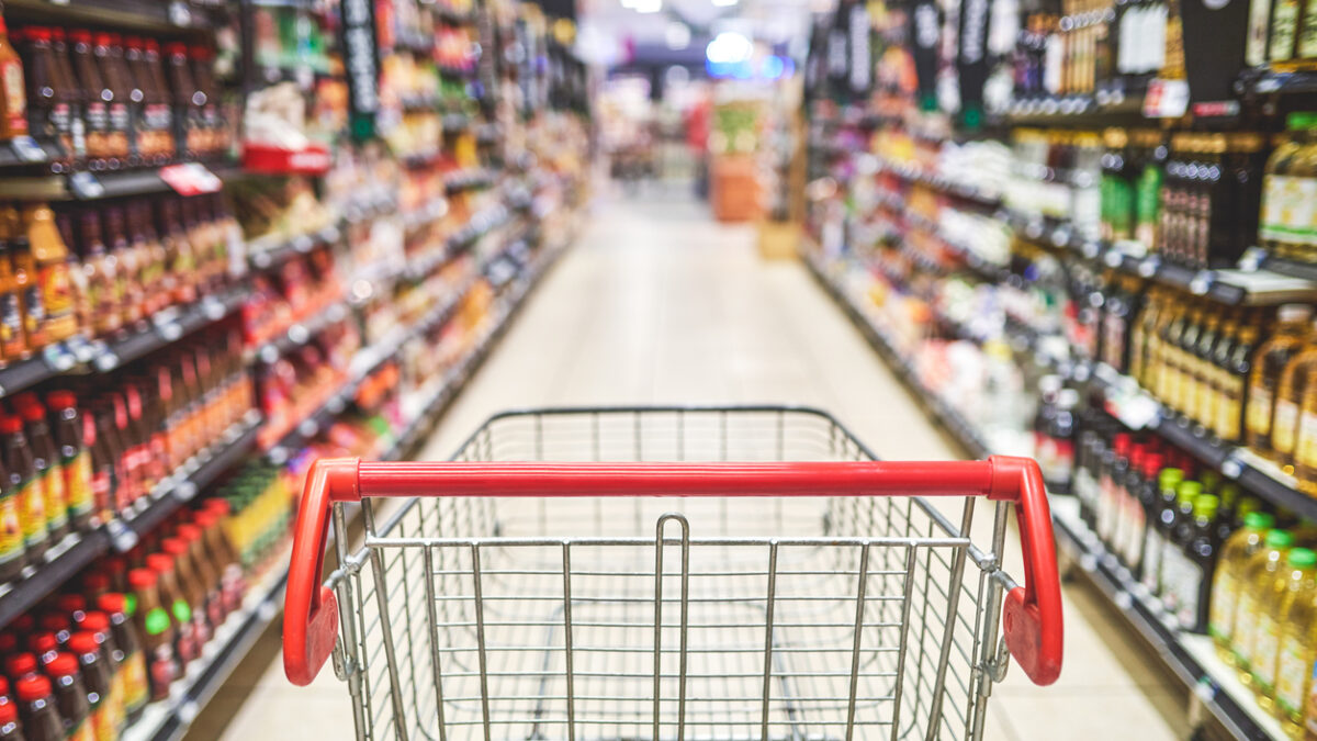 Shot of an empty shopping cart in a grocery store