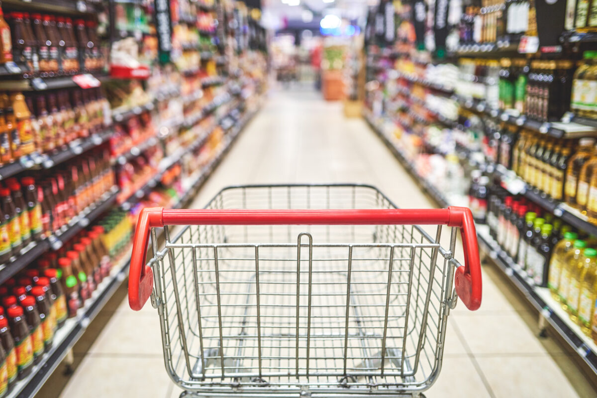 Shot of an empty shopping cart in a grocery store