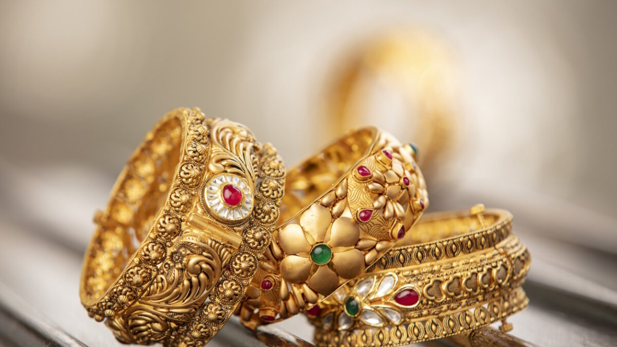Fancy designer antique golden bracelets for woman fashion studio shot.