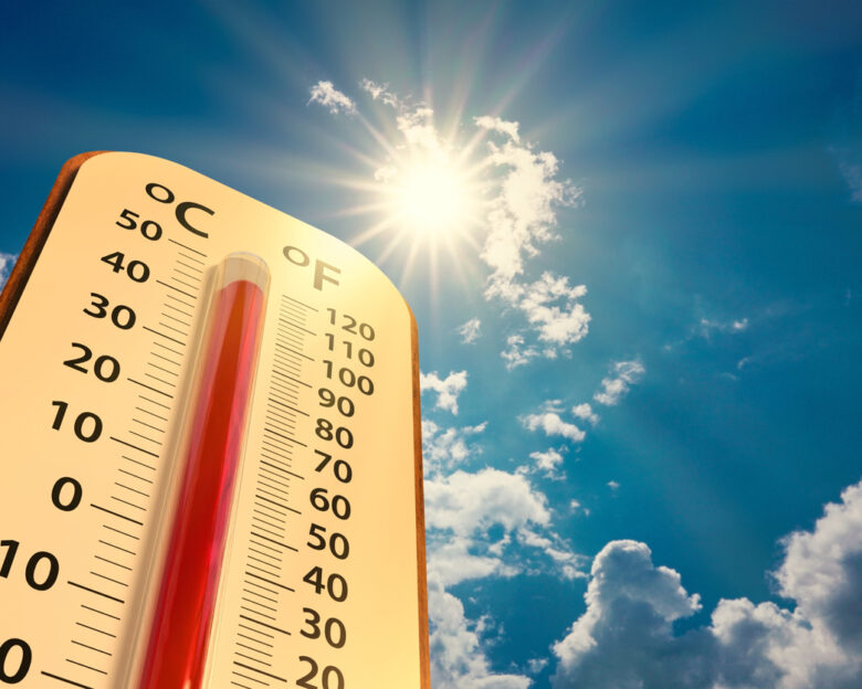 climate change, low angle view Thermometer on blue sky with sun shining in summer show increase temperature, concept global warming