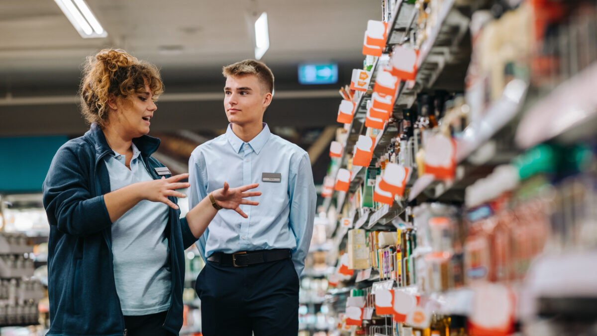 Store incharge training young worker. Supermarket manager giving training to a trainee.
