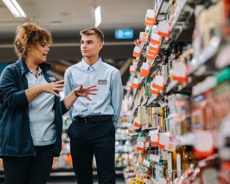Store incharge training young worker. Supermarket manager giving training to a trainee.