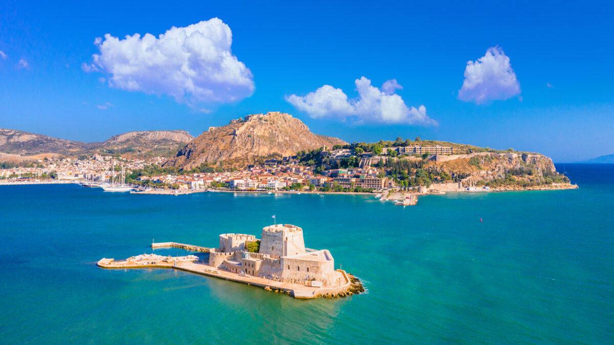 The old town of Nafplion in Greece with tiled roofs, small port, bourtzi castle, Palamidi fortress