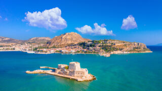 The old town of Nafplion in Greece with tiled roofs, small port, bourtzi castle, Palamidi fortress