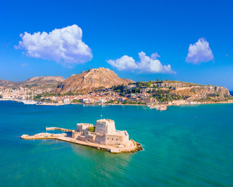 The old town of Nafplion in Greece with tiled roofs, small port, bourtzi castle, Palamidi fortress