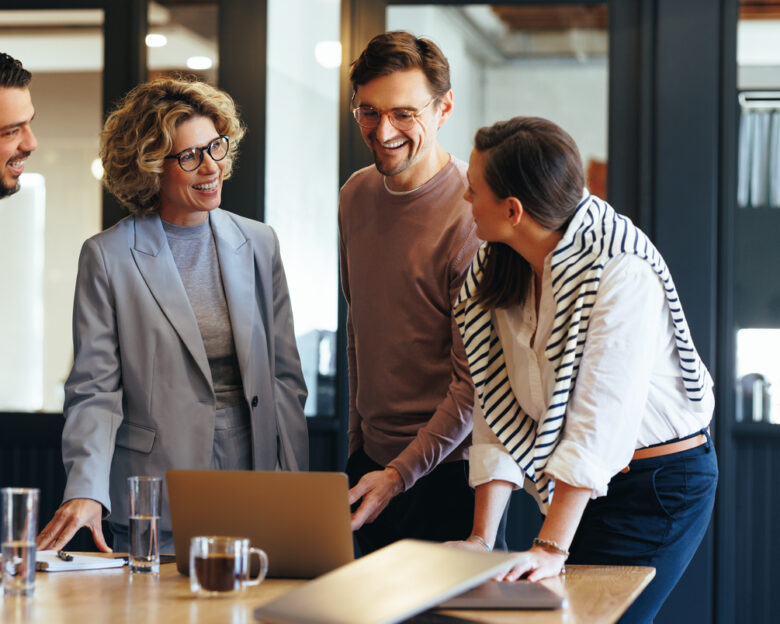 Group of business people having a meeting in a tech company. Creative business professionals planning a project in an office. Teamwork and collaboration in a modern workplace.