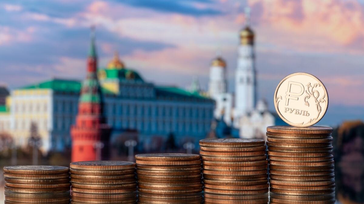 Coin with the symbol of the Russian ruble against the backdrop of the Moscow Kremlin