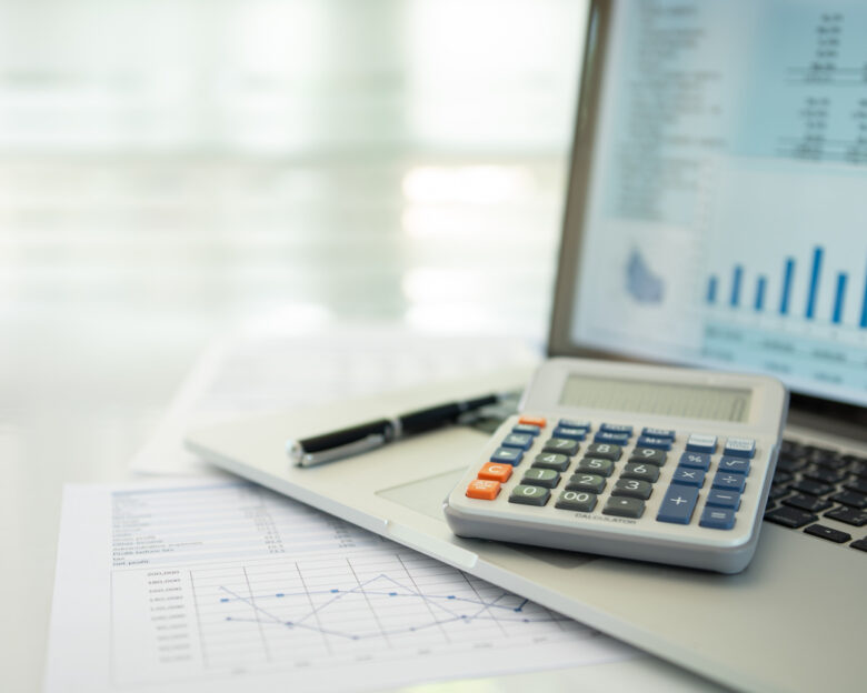 calculator, account statement and business report with financial budget portfolio show on screen laptop computer. accounting business concept.