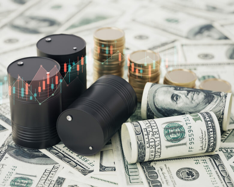 Black Oil Barrels and Stack Coin over Financial Charts on 100 American Dollar Bills