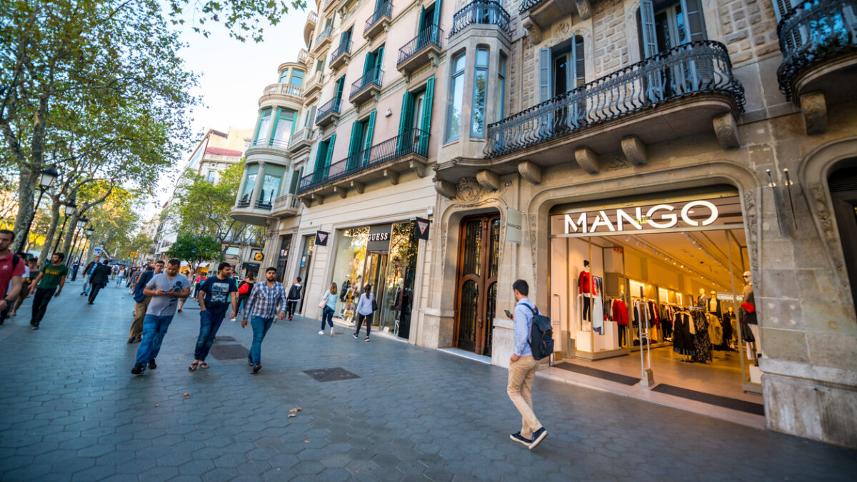 Barcelona, Spain - September 29, 2016: People shopping on famous Passeig de Gracia, shopping street full of trendy shops. Mango store