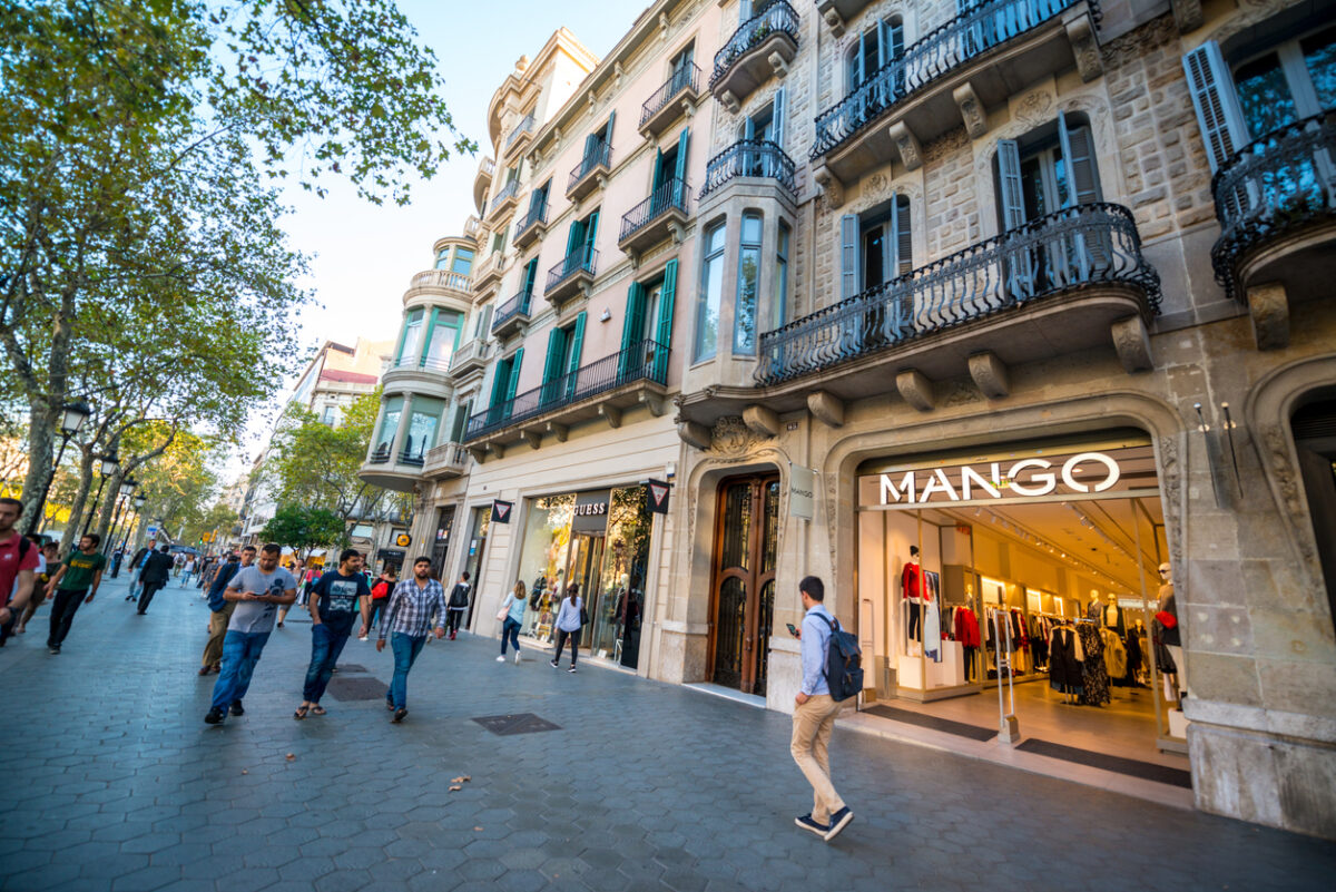 Barcelona, Spain - September 29, 2016: People shopping on famous Passeig de Gracia, shopping street full of trendy shops. Mango store