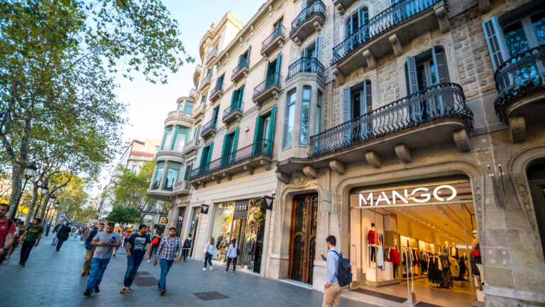 Barcelona, Spain - September 29, 2016: People shopping on famous Passeig de Gracia, shopping street full of trendy shops. Mango store
