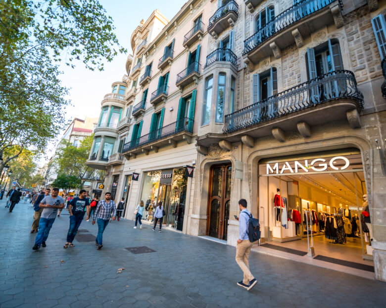 Barcelona, Spain - September 29, 2016: People shopping on famous Passeig de Gracia, shopping street full of trendy shops. Mango store
