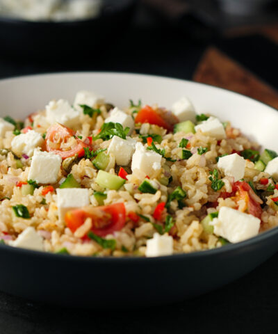 Home made freshness Healthy fluffy brown rice with chopped parsley,capers,cherry tomatoes and cucumbers and feta cubes.