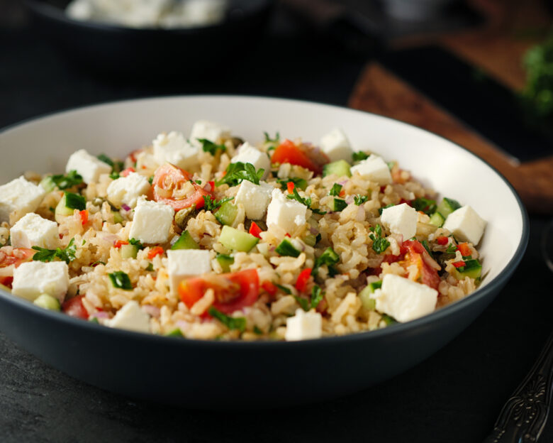 Home made freshness Healthy fluffy brown rice with chopped parsley,capers,cherry tomatoes and cucumbers and feta cubes.