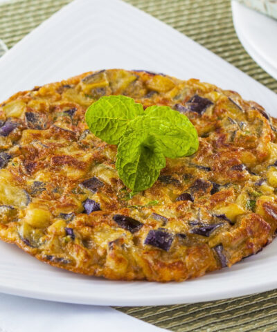 Eggplant omelet served on a white plate. Perfect for brunch.