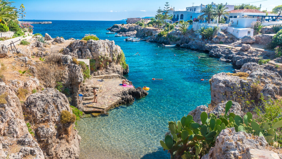People swimming in a beach in Avlemonas village in Kythera island in Greece