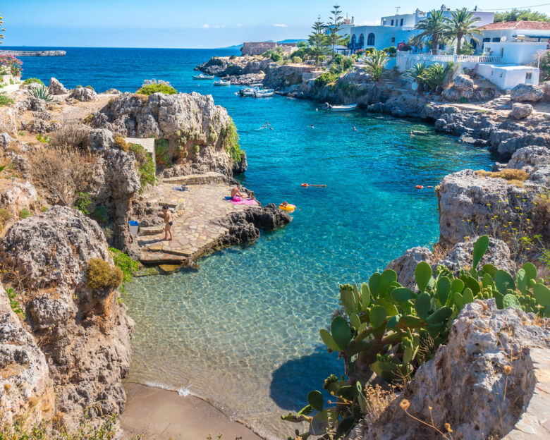 People swimming in a beach in Avlemonas village in Kythera island in Greece