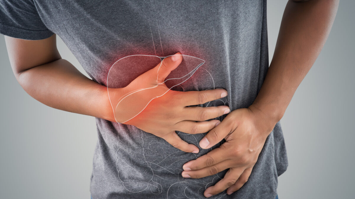 The photo of large intestine is on the man's body against gray background, People With Stomach ache problem concept, Male anatomy