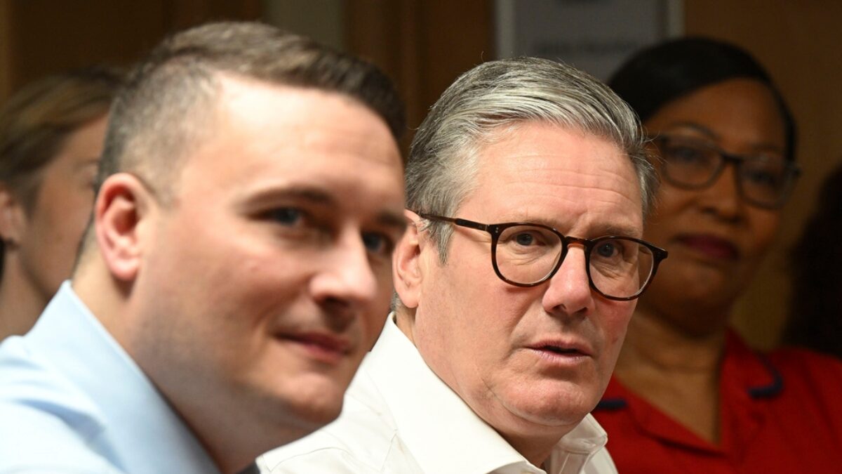 Britain's Prime Minister Keir Starmer, center, accompanied by Health Secretary Wes Streeting, left, visit a healthcare provider to deliver remarks on reducing NHS wait times, in Surrey, England, Monday, Jan. 6, 2025,