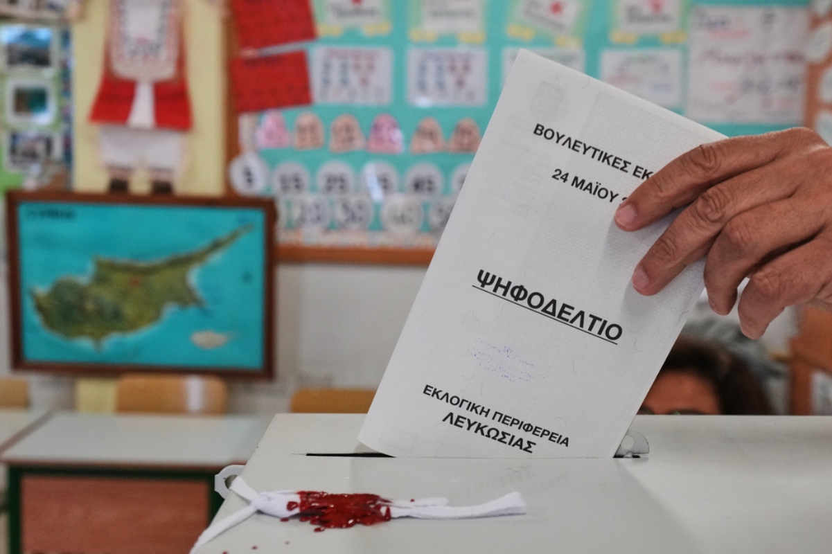 A voter casts a ballot at a polling station during the parliamentary elections in capital Nicosia, Cyprus