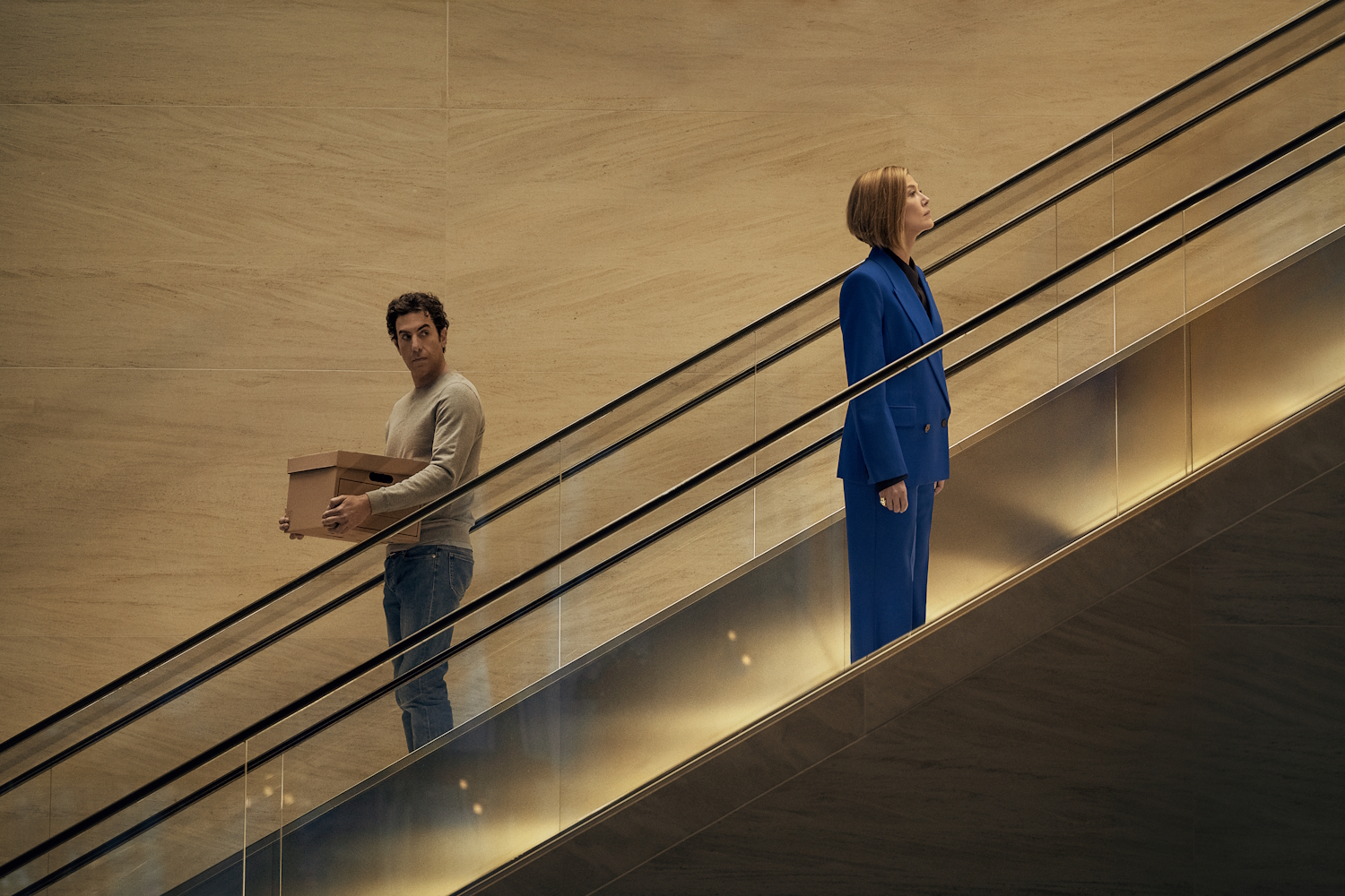 Ladies First. (L-R) Sacha Baron Cohen as Damien Sachs and Rosamund Pike as Alex Fox in Ladies First. Cr. Rob Youngson