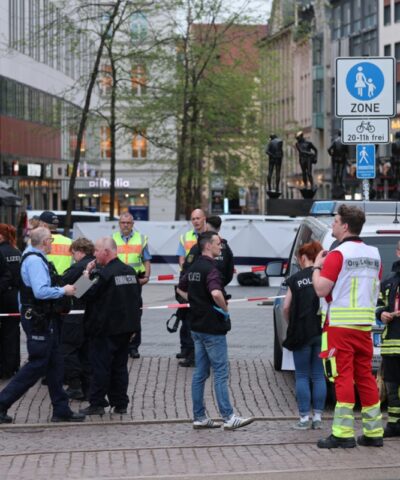04 May 2026, Saxony, Leipzig: Emergency services stand at the entrance to Grimmaische Straße. A car has crashed into several people in Leipzig.