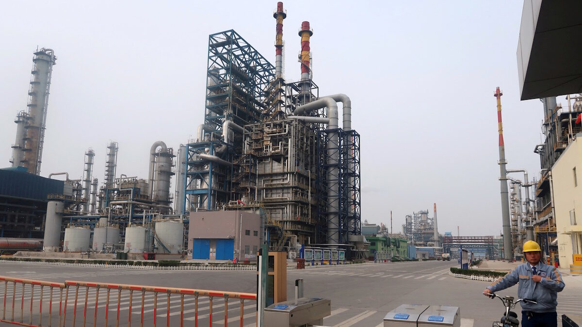FILE PHOTO: A man is seen at an exit of the refinery plants of Chambroad Petrochemicals in Binzhou, Shandong province, China October 24, 2019. Picture taken October 24, 2019.