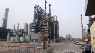 FILE PHOTO: A man is seen at an exit of the refinery plants of Chambroad Petrochemicals in Binzhou, Shandong province, China October 24, 2019. Picture taken October 24, 2019.