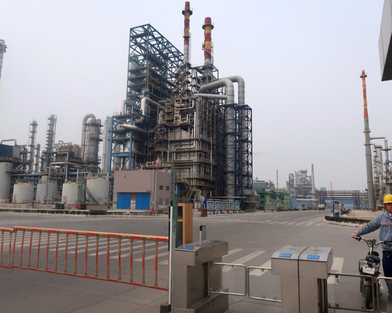 FILE PHOTO: A man is seen at an exit of the refinery plants of Chambroad Petrochemicals in Binzhou, Shandong province, China October 24, 2019. Picture taken October 24, 2019.