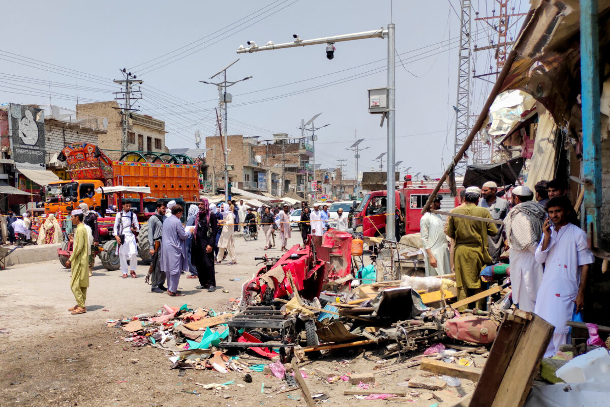 People and police officers in plain clothes gather after a blast at a market in Lakki Marwat, Khyber Pakhtunkhwa province, Pakistan, May 12, 2026. Picture taken with a mobile phone. REUTERS