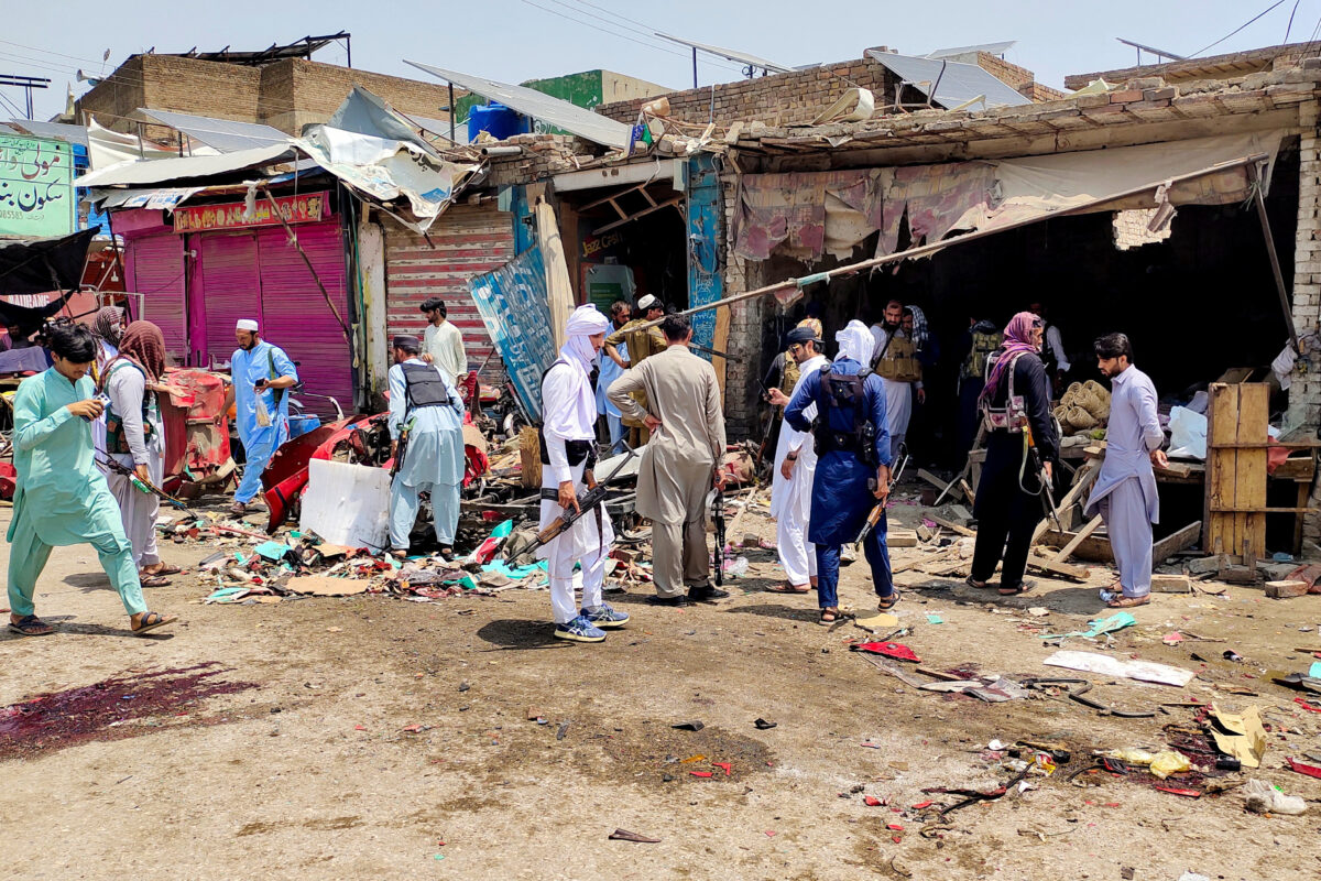 Police officers in plain clothes gather after a blast at a market in Lakki Marwat, Khyber Pakhtunkhwa province, Pakistan, May 12, 2026. Picture taken with a mobile phone. REUTERS/Syed Basit