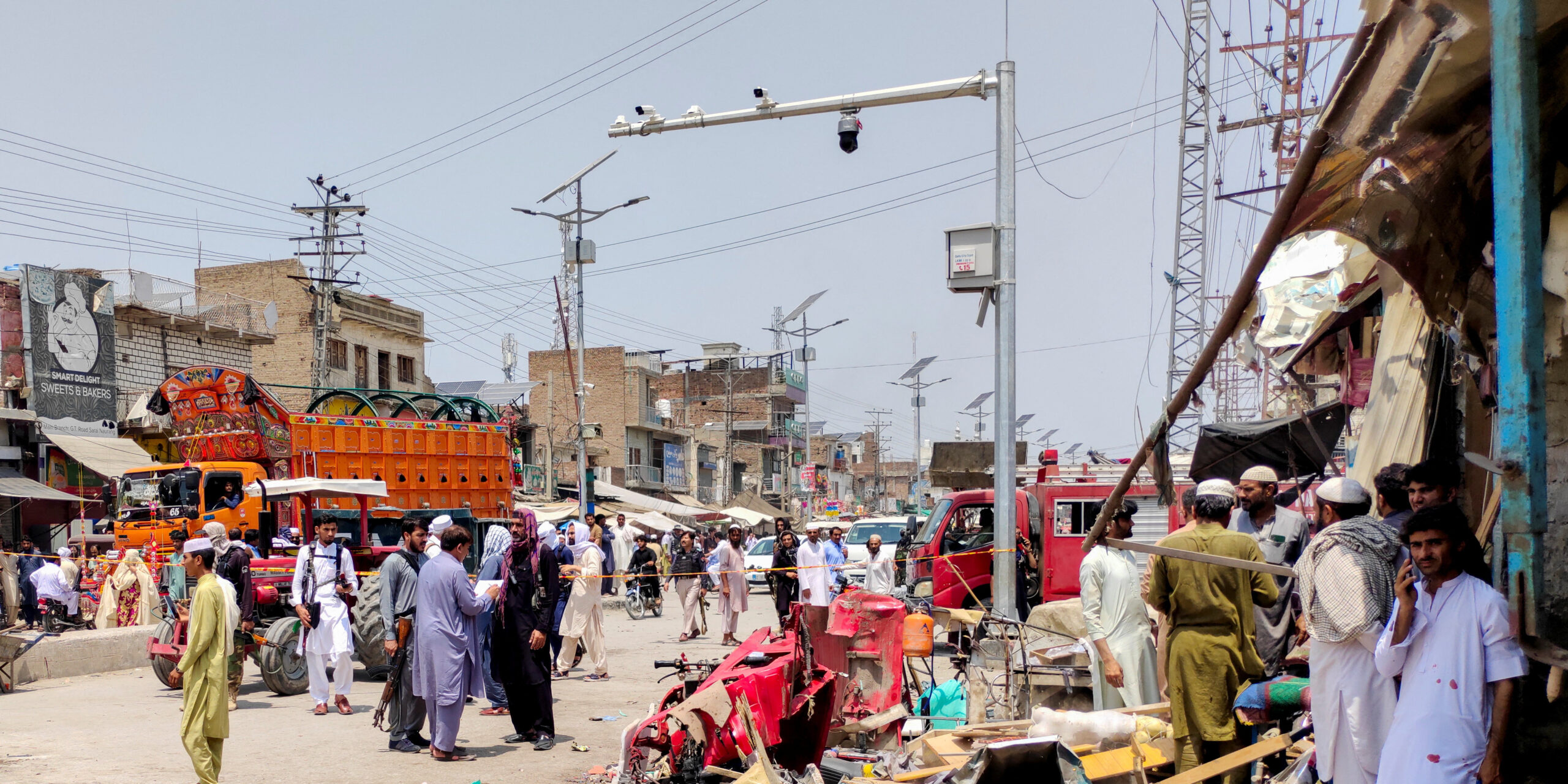 People and police officers in plain clothes gather after a blast at a market in Lakki Marwat, Khyber Pakhtunkhwa province, Pakistan, May 12, 2026. Picture taken with a mobile phone. REUTERS/Syed Basit