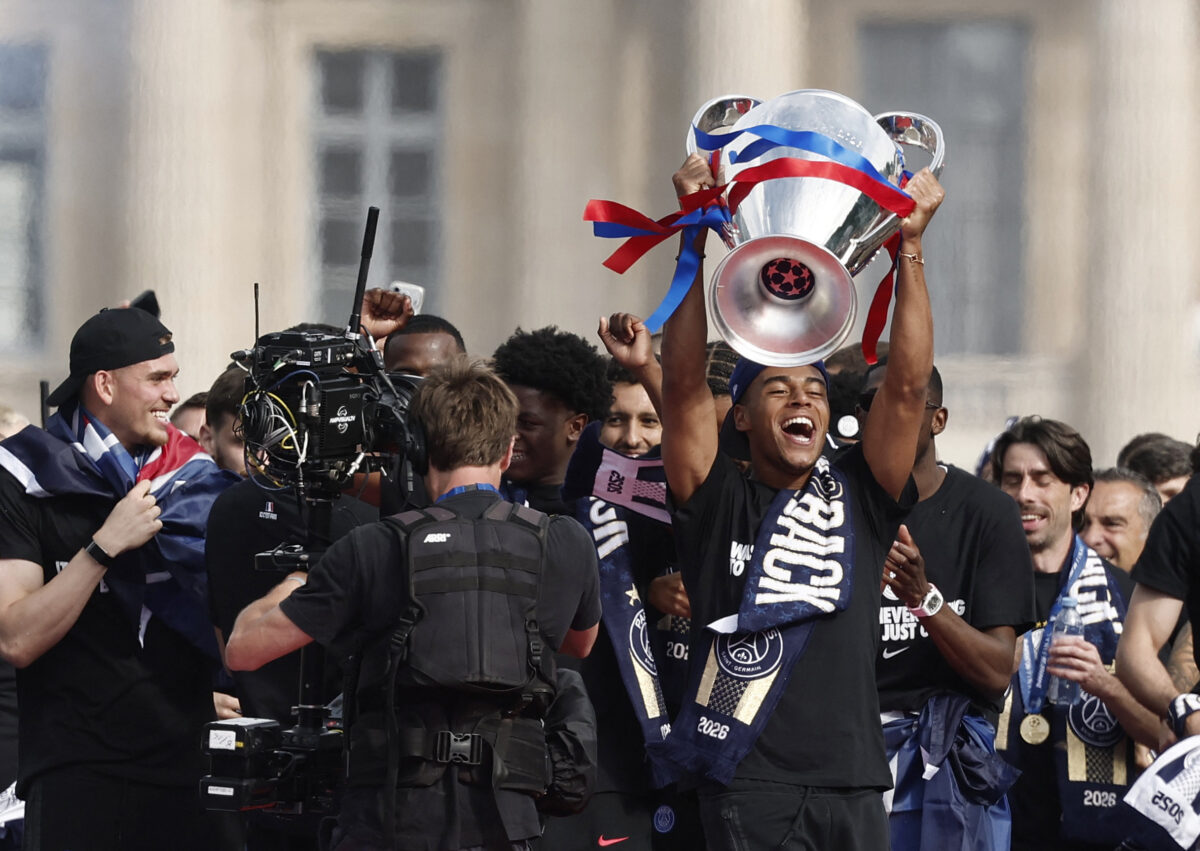 Soccer Football - UEFA Champions League - Paris St Germain celebrate winning the UEFA Champions League Final - Paris, France - May 31, 2026 Paris St Germain's Desire Doue celebrates with the trophy after winning the UEFA Champions League REUTERS