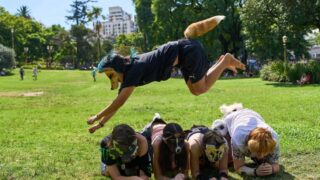 FILE - A youth jumps over other therians, people who say they identify as non-human animals, during a gathering in a square in Buenos Aires, Argentina, Feb. 22, 2026.