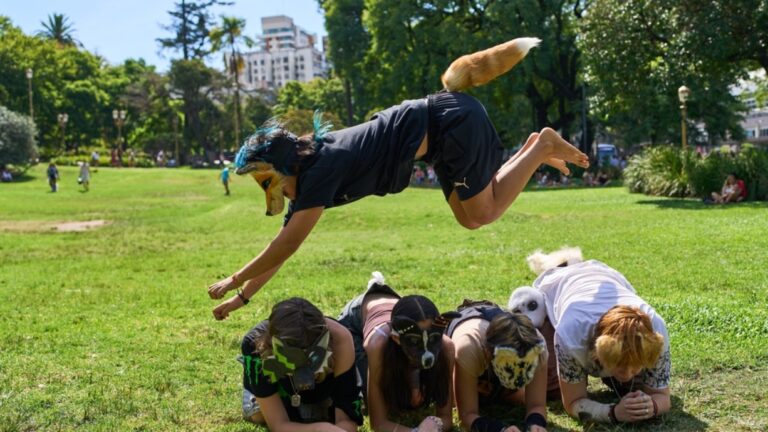 FILE - A youth jumps over other therians, people who say they identify as non-human animals, during a gathering in a square in Buenos Aires, Argentina, Feb. 22, 2026.