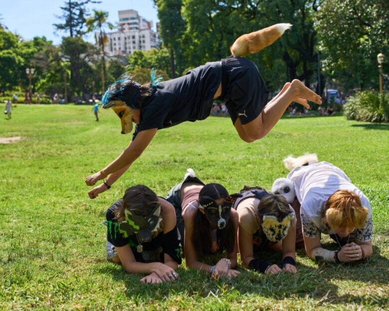 FILE - A youth jumps over other therians, people who say they identify as non-human animals, during a gathering in a square in Buenos Aires, Argentina, Feb. 22, 2026.
