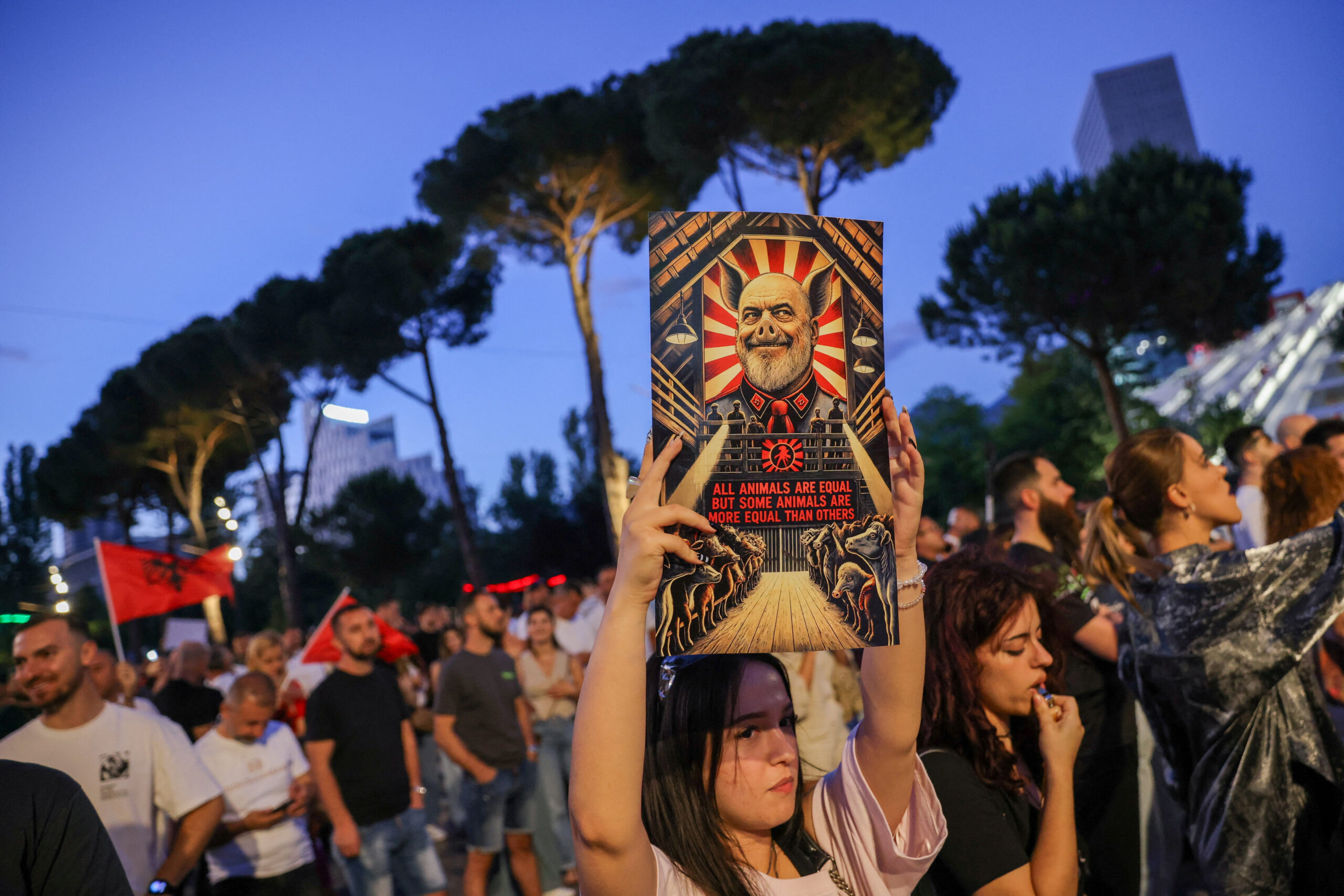 A protester holds a placard during a protest against a luxury resort, a plan by a company linked to Donald Trump's son-in-law, Jared Kushner, on an environmentally sensitive part of the Adriatic coast, in Tirana, Albania, June 12, 2026. REUTERS/Valdrin Xhemaj