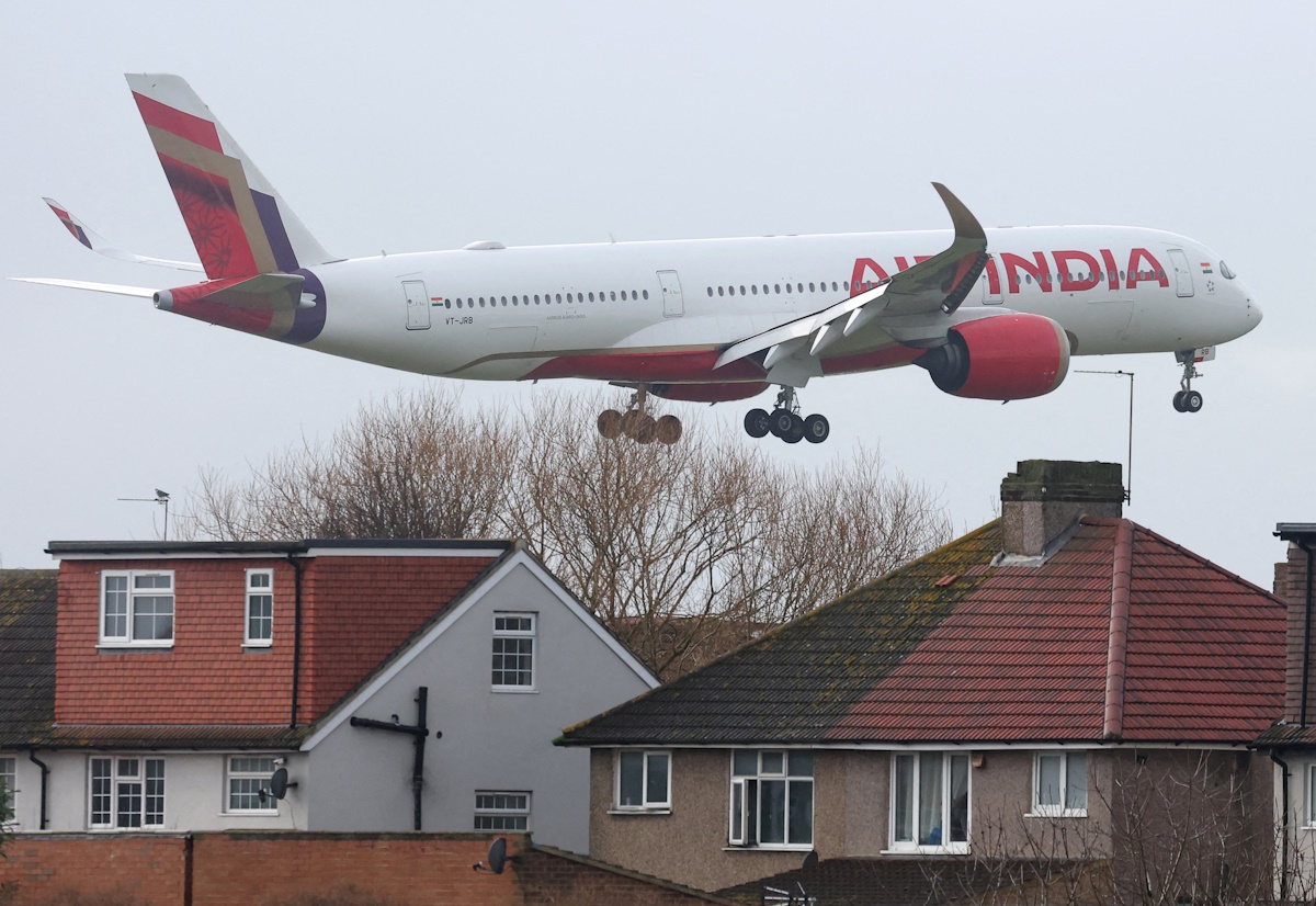 FILE PHOTO: An Air India passenger plane flies near houses as it makes its landing approach to Heathrow Airport in west London, Britain, January 28, 2025.