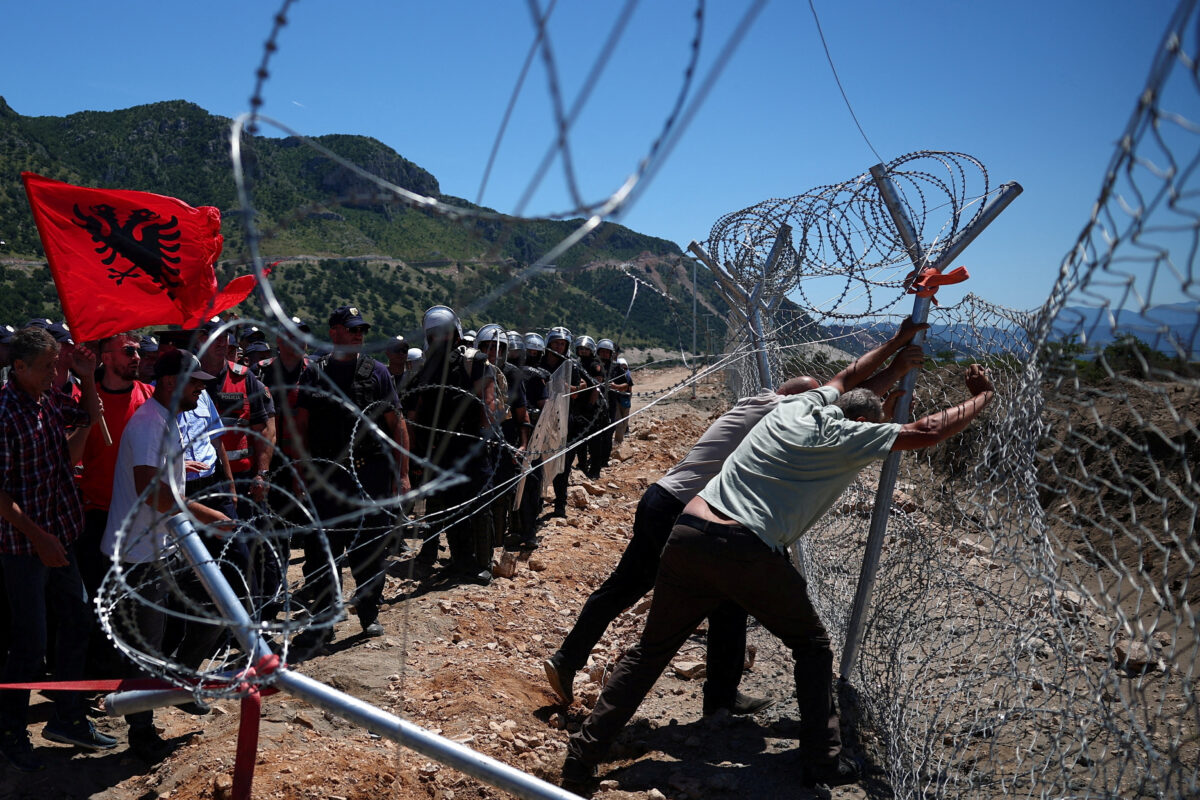 Protesters who say their land has been taken unjustly, tear down the fence where a tourist resort is to be built by the Adriatic coast, in Rrjoll, near Shkodra, Albania, June 13, 2026. REUTERS/Florion Goga