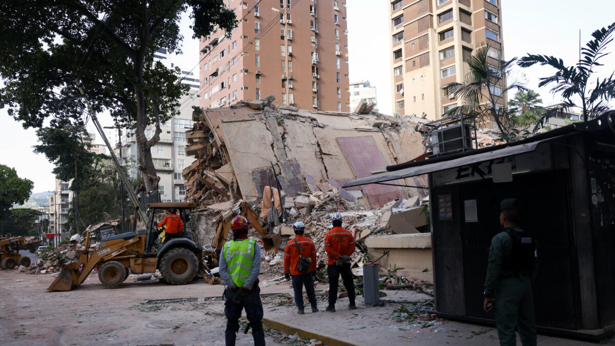 Emergency services work at the site of a collapsed building after earthquakes hit the country, in Caracas, Venezuela, June 25, 2026. REUTERS