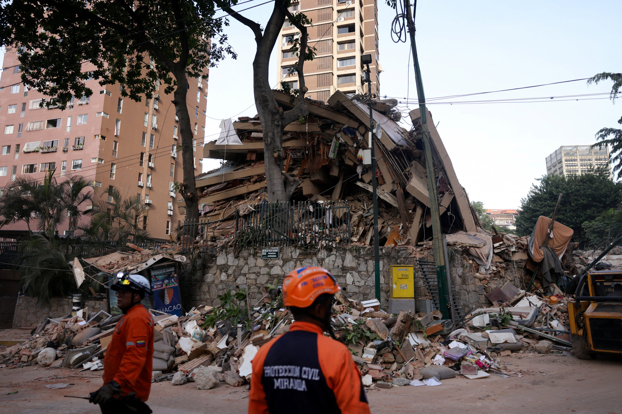 Emergency services work at the site of a collapsed building after earthquakes hit the country, in Caracas, Venezuela, June 25, 2026. REUTERS
