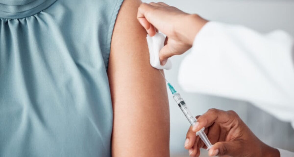 Hands, medical and doctor with patient for vaccine in a clinic for healthcare treatment for prevention. Closeup of a nurse doing a vaccination injection with a needle syringe in a medicare hospital.