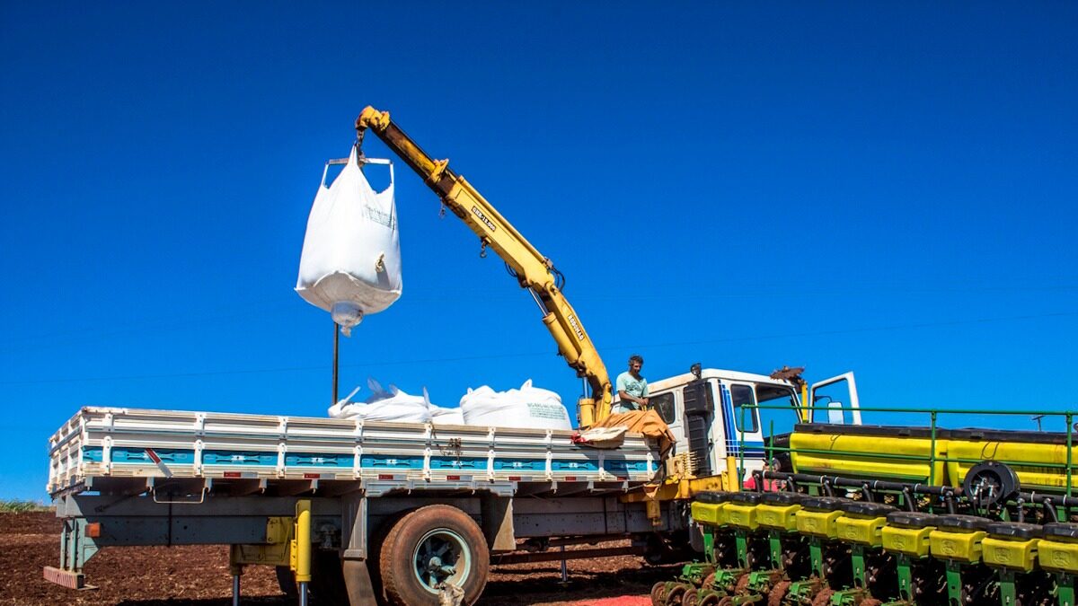 Rolandia PR, Brazil, February 28, 2013. Worker carry an agricultural machine with fertilizer to be used along with corn planting in Rolandia, northern region of Parana State.