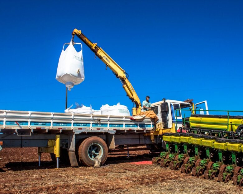 Rolandia PR, Brazil, February 28, 2013. Worker carry an agricultural machine with fertilizer to be used along with corn planting in Rolandia, northern region of Parana State.