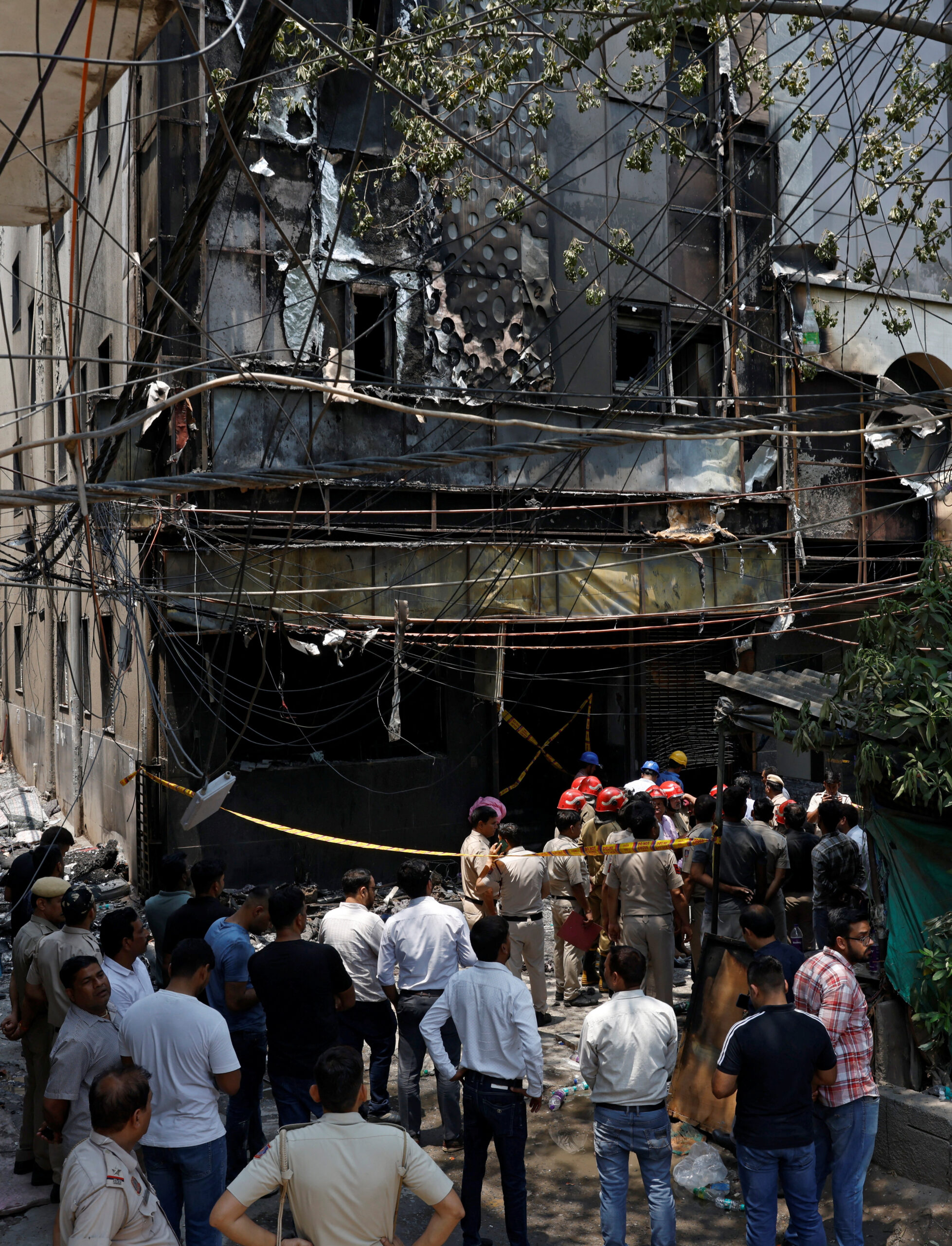 A police officer walks in between security tapes at the spot after a fire at a hotel in New Delhi, India, June 3, 2026. REUTERS/Adnan Abidi
