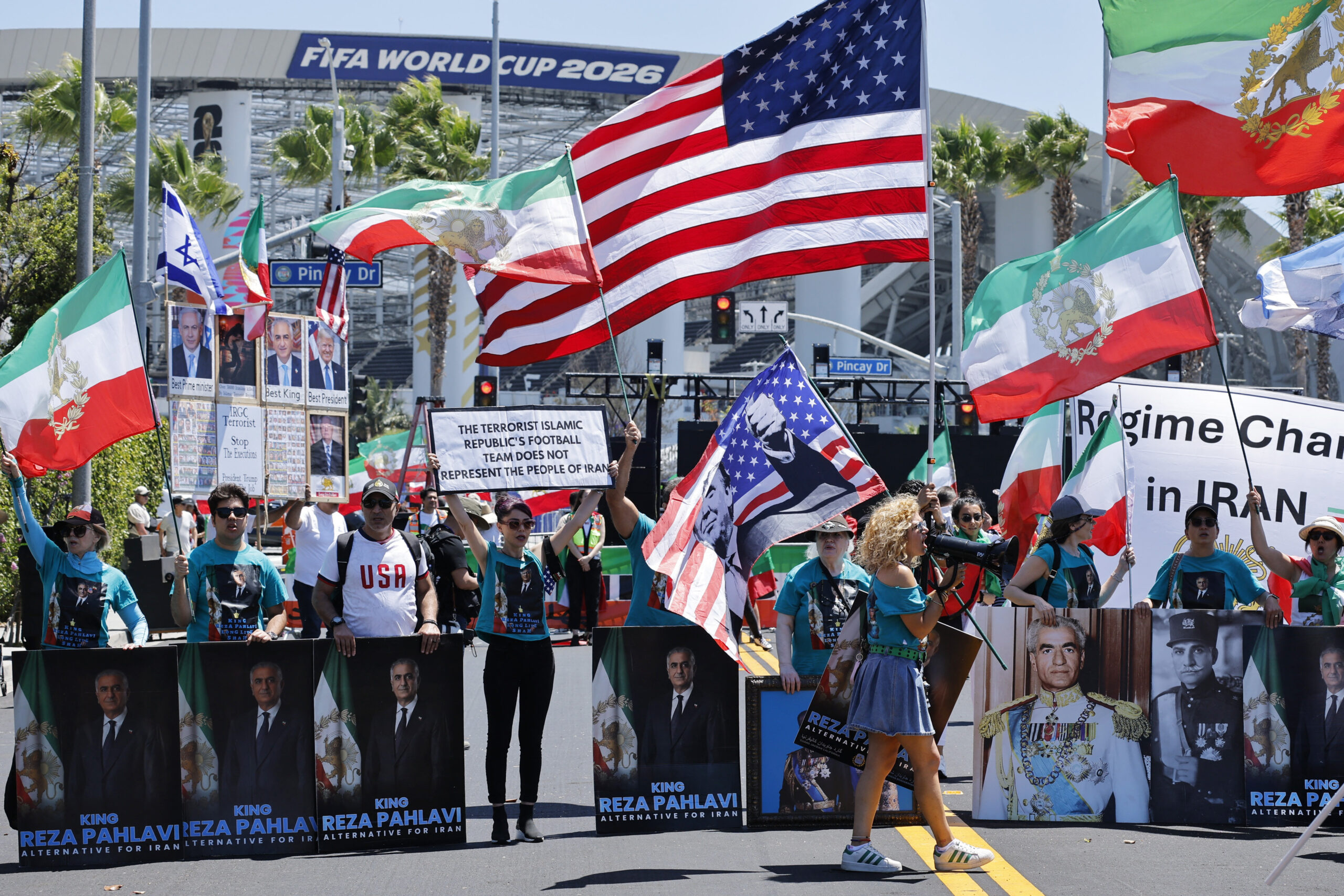 Soccer Football - FIFA World Cup 2026 - Group G - Iran v New Zealand - Los Angeles Stadium, Inglewood, California, U.S. - June 15, 2026 Banners of an Iranian political activist Reza Pahlavi and flags of the U.S. and Iran are displayed during a protest outside the stadium before the match REUTERS